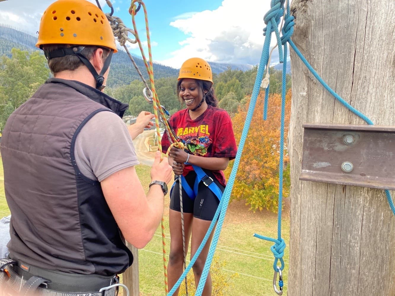 Student learning ropes and climbing skills with an instructor